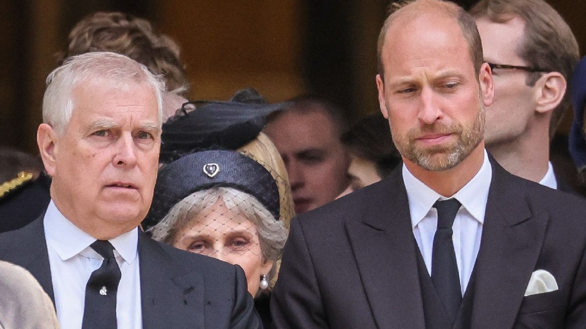 Fotografie cu prințul Andrew și prințul William, îmbrăcați în costume negre, cămăși albe și cravate negre, înconjurați de mai multe persoane, între care și o femeie blondă cu pălărie.