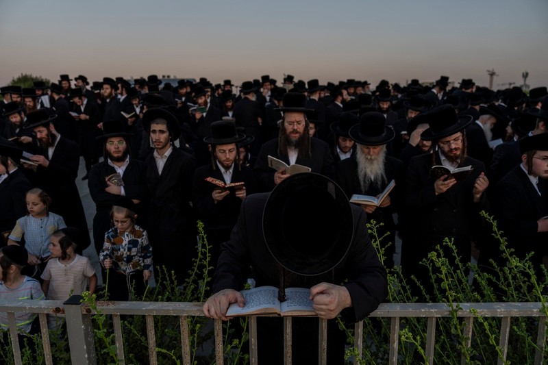 Ultra-Orthodox Jewish men and children of the Kiryat Sanz Hasidic sect prays on a hill overlooking the Mediterranean Sea as they participate in a Tashlich ceremony, in Netanya, Israel, Thursday, Oct. 10, 2024. Tashlich, which means "to cast away" in Hebrew, is the practice in which Jews go to a large flowing body of water and symbolically "throw away" their sins by throwing a piece of bread, or similar food, into the water before the Jewish holiday of Yom Kippur.,Image: 919142643, License: Rights-managed, Restrictions: This content is intended for editorial use only. For other uses, additional clearances may be required., Model Release: no
