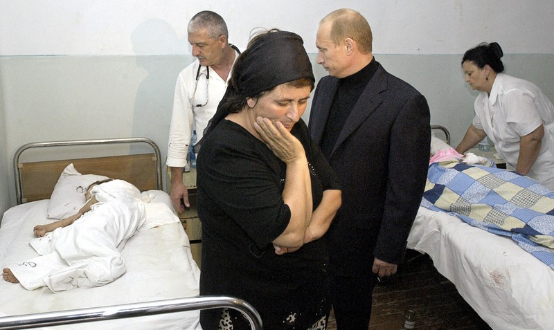 Russin President Vladimir Putin (2nd R) looks at injured child as the mother touches her face during his visit to a hospital in the town of Beslan, North Ossetia, 04 September 2004. Russian President Vladimir Putin on Saturday paid his respects to the 250 dead and hundreds of wounded from a horrific battle between security forces and heavily-armed militants holding 1,000 hostages at a school.,Image: 15936079, License: Rights-managed, Restrictions: , Model Release: no