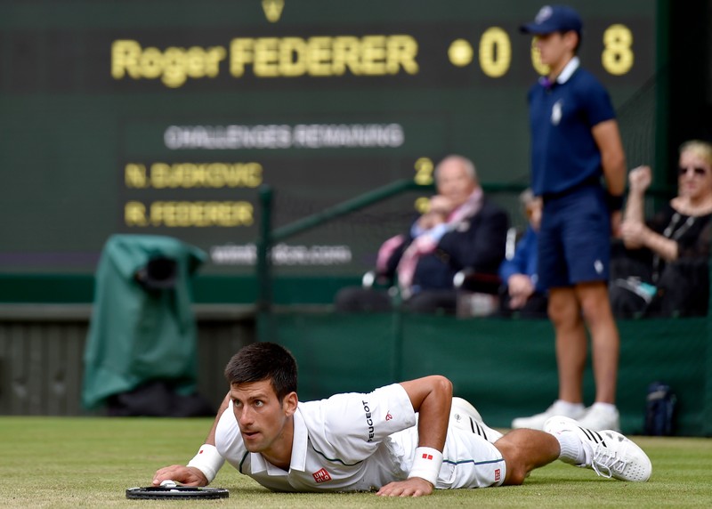 epa04844130 Novak Djokovic of Serbia in action against Roger Federer of Switzerland during their final match for the Wimbledon Championships at the All England Lawn Tennis Club, in London, Britain, 12 July 2015. EPA/TOBY MELVILLE / POOL EDITORIAL USE ONLY/NO COMMERCIAL SALES
