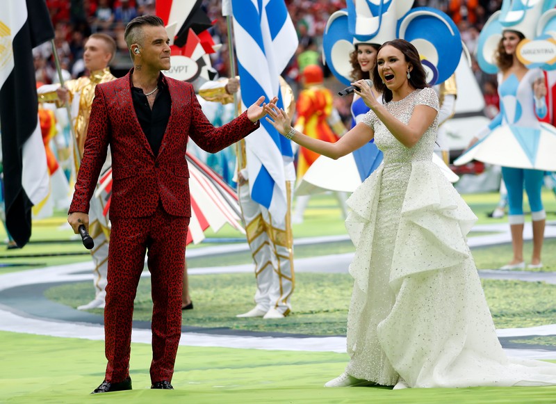 epa06807497 English singer Robbie Williams (L) and Russian soprano Aida Garifullina perform during the opening ceremony prior to the FIFA World Cup 2018 group A preliminary round soccer match between Russia and Saudi Arabia in Moscow, Russia, 14 June 2018. (RESTRICTIONS APPLY: Editorial Use Only, not used in association with any commercial entity - Images must not be used in any form of alert service or push service of any kind including via mobile alert services, downloads to mobile devices or MMS messaging - Images must appear as still images and must not emulate match action video footage - No alteration is made to, and no text or image is superimposed over, any published image which: (a) intentionally obscures or removes a sponsor identification image; or (b) adds or overlays the commercial identification of any third party which is not officially associated with the FIFA World Cup) EPA-EFE/FELIPE TRUEBA EDITORIAL USE ONLY