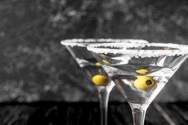 martini cocktail at wooden background close up.