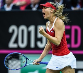 epa05026614 Russia's Maria Sharapova in action against Petra Kvitova of Czech Republic during their Tennis Fed Cup Final match in Prague, Czech Republic, 15 November 2015. EPA/FILIP SINGER
