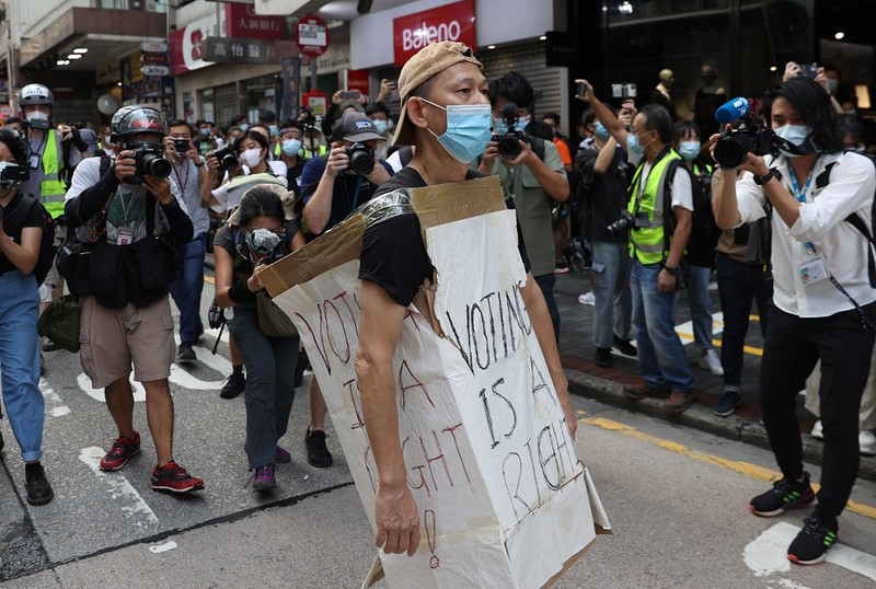 epa08650141 A protester wearing a cardboard sign takes part in a rally against the postponement of the Legislative Council Elections in Hong Kong, China, 06 September 2020. Activists answered online calls to protest on the day the Legislative Council polls were due to be held on 06 September 2020 until the government postponed them for a year, citing Covid-19 and the risk to public health. EPA-EFE/JEROME FAVRE