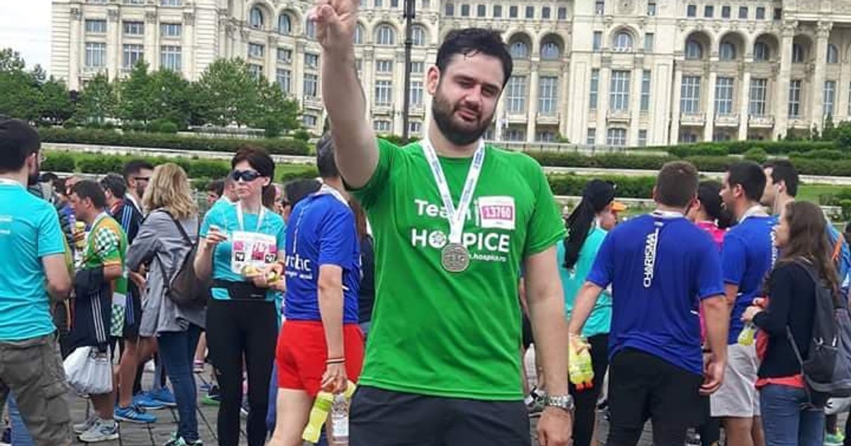 Scenaristul de la Vocea României aleargă la semimaraton. Bogdan Neculai, arătând semnul victoriei, după un semimaraton