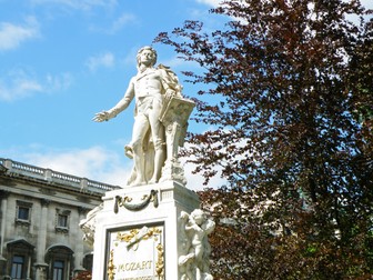 Statue of Wolfgang Amadeus Mozart against sunny blue sky, Burggarten Park in Vienna, Austria