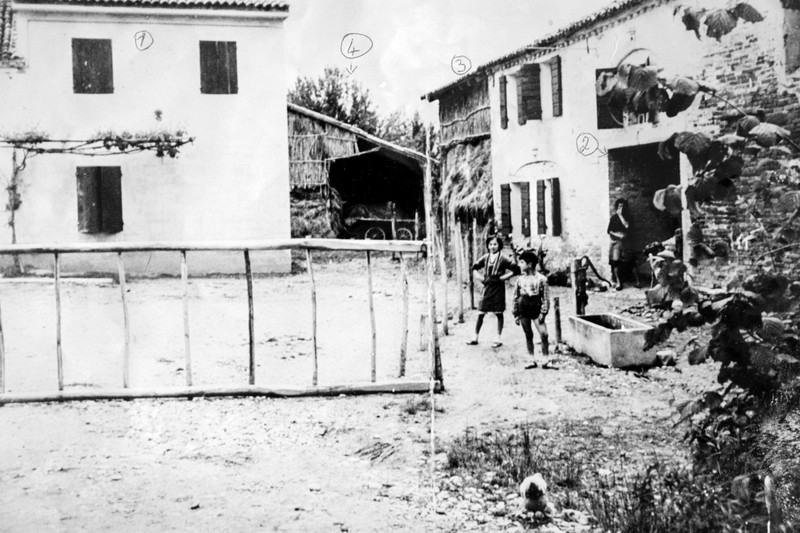 BNPS.co.uk (01202 558833)?Pic: EzraFamily/BNPS Post war picture showing the building occupied by the Germans (left) and the barn in which the villagers were held (far right). Brighton nonagenarian Gabriella Ezra(91) has finally been recognised for her wartime heroics... The extraordinary story of how a teenage girl saved an entire village from being executed by the Nazis has come to light after she finally received a gallantry award nearly 74 years later. Fearless Gabriella Ezra, 91, who lives in Brighton, Sussex, intervened to stop her father Luigi and 37 other inhabitants of a rural village in her native Italy from being massacred by a firing squad during the chaotic last days of WW2. She has now been awarded an Italian Star of Italy medal after her son Mark wrote to the Italian embassy to make them aware of her remarkable actions on the morning April 28, 1945. Gabriella, who was 17 years old at the time, chased after a German officer and pleaded with him to show mercy to the villagers of Capella di Scorze, near Venice, who had been rounded up and locked in a cowshed. The Germans were after retribution following an attack on their men by Italian partisans which had left several of them wounded. ***EXCLUSIVE***