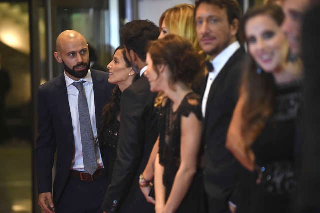 Barcelona's football player Javier Mascherano (L) poses with other guests on a red carpet during Argentine football star Lionel Messi and Antonella Roccuzzos wedding in Rosario, Santa Fe province, Argentina on June 30, 2017. Footballers and celebrities including pop singer Shakira gathered Friday for the "wedding of the century" in Lionel Messi's Argentine hometown as the Barcelona superstar prepared to marry his childhood sweetheart Antonella Roccuzzo. / AFP PHOTO / EITAN ABRAMOVICH