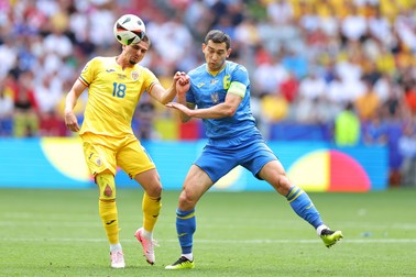 17 June 2024, Bavaria, Munich: Romania's Razvan Marin (L) and Ukraine's Taras Stepanenko battle for the ball during the UEFA Euro 2024 group E soccer match between Romania and Ukraine at the Munich Football Arena. Photo: Daniel Karmann/dpa