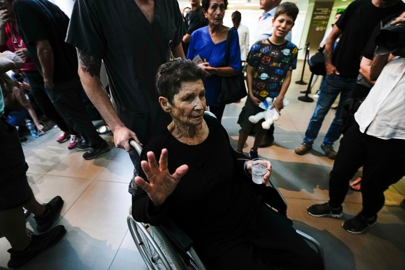 Yocheved Lifshitz, 85, who was held hostage in Gaza after being abducted during Hamas' bloody Oct. 7 attack on Israel, waves to the media, a day after being released by Hamas militants, at Ichilov Hospital in Tel Aviv, Israel, Tuesday, Oct. 24, 2023.,Image: 816268975, License: Rights-managed, Restrictions: This content is intended for editorial use only. For other uses, additional clearances may be required., Model Release: no