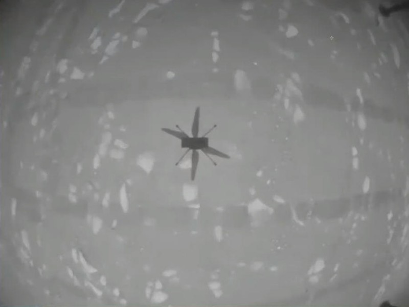 epa09144917 A handout video still taken from a livestream by NASA shows shadow of the Ingenuity Mars Helicopter during its first test flight on Mars, 19 April 2021. According to NASA, Ingenuity has successfully peformed a short flight on Mars, the first ever helicopter flight on another planet. A key objective for Perseverance's mission on Mars is astrobiology, including the search for signs of ancient microbial life. EPA-EFE/NASA/JPL-Caltech/HANDOUT HANDOUT EDITORIAL USE ONLY/NO SALES