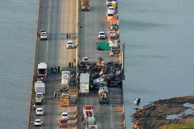In this aerial photo, responders are seen near wreckage in the aftermath of a multi-vehicle pileup on I-55 in Manchac, La., Monday, Oct. 23, 2023. A “superfog” of smoke from south Louisiana marsh fires and dense morning fog caused multiple traffic crashes involving scores of cars.,Image: 816206852, License: Rights-managed, Restrictions: This content is intended for editorial use only. For other uses, additional clearances may be required., Model Release: no