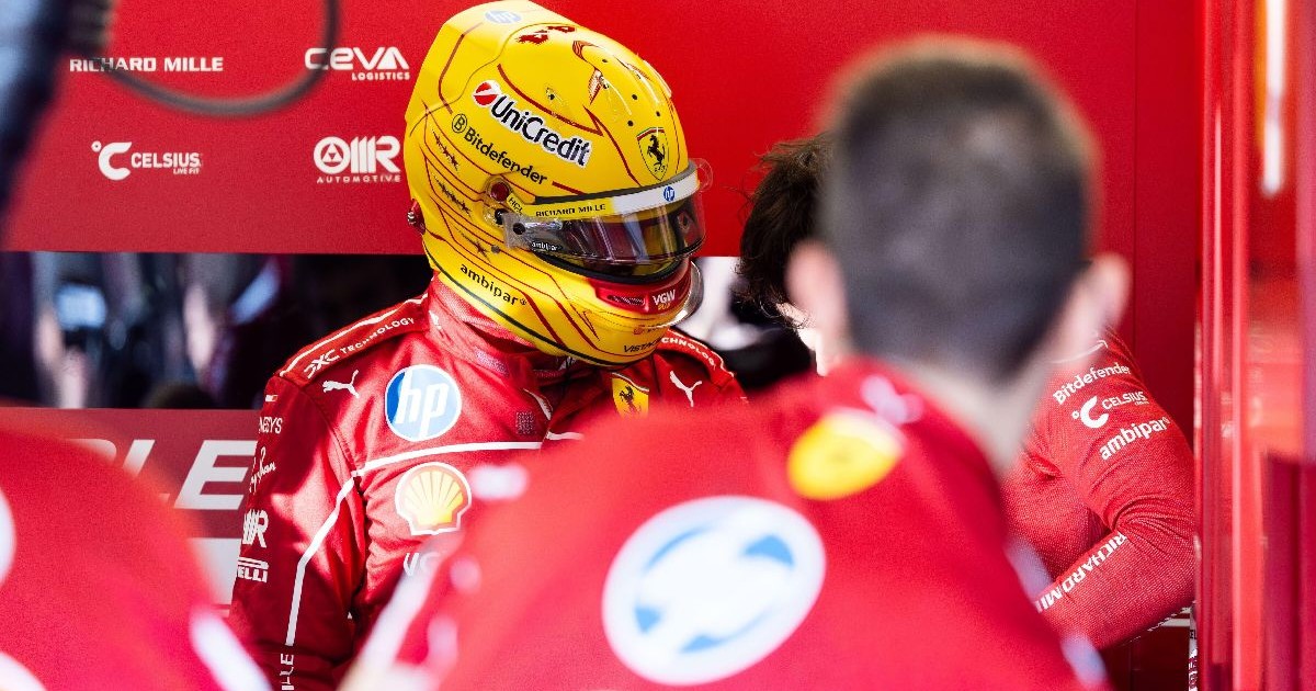 Lewis Hamilton, îmbărcat în combinezonul roșu Ferrari, având o cască galbenă.