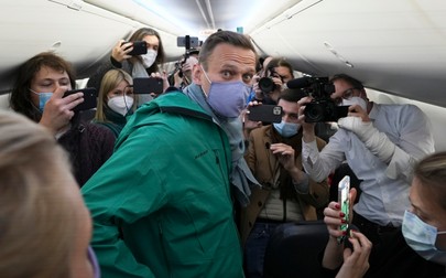 FILE - Alexei Navalny is surrounded by journalists inside a plane carrying him back to Russia from the airport near Berlin, Germany, on Sunday, Jan. 17, 2021. Navalny, who was President Vladimir Putin’s fiercest political foe, died in a Russian prison on Feb. 16, 2024. Over the last decade, Putin's Russia evolved from a country that tolerates at least some dissent to one that ruthlessly suppresses it. Arrests, trials and long prison terms — once rare — are commonplace.,Image: 854094721, License: Rights-managed, Restrictions: This content is intended for editorial use only. For other uses, additional clearances may be required. FILE PHOTO, Model Release: no, Pictured: Alexei Navalny,Vladimir Putin
