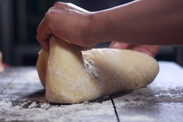 Close up image of bakery chef making bread dough in the kitchen