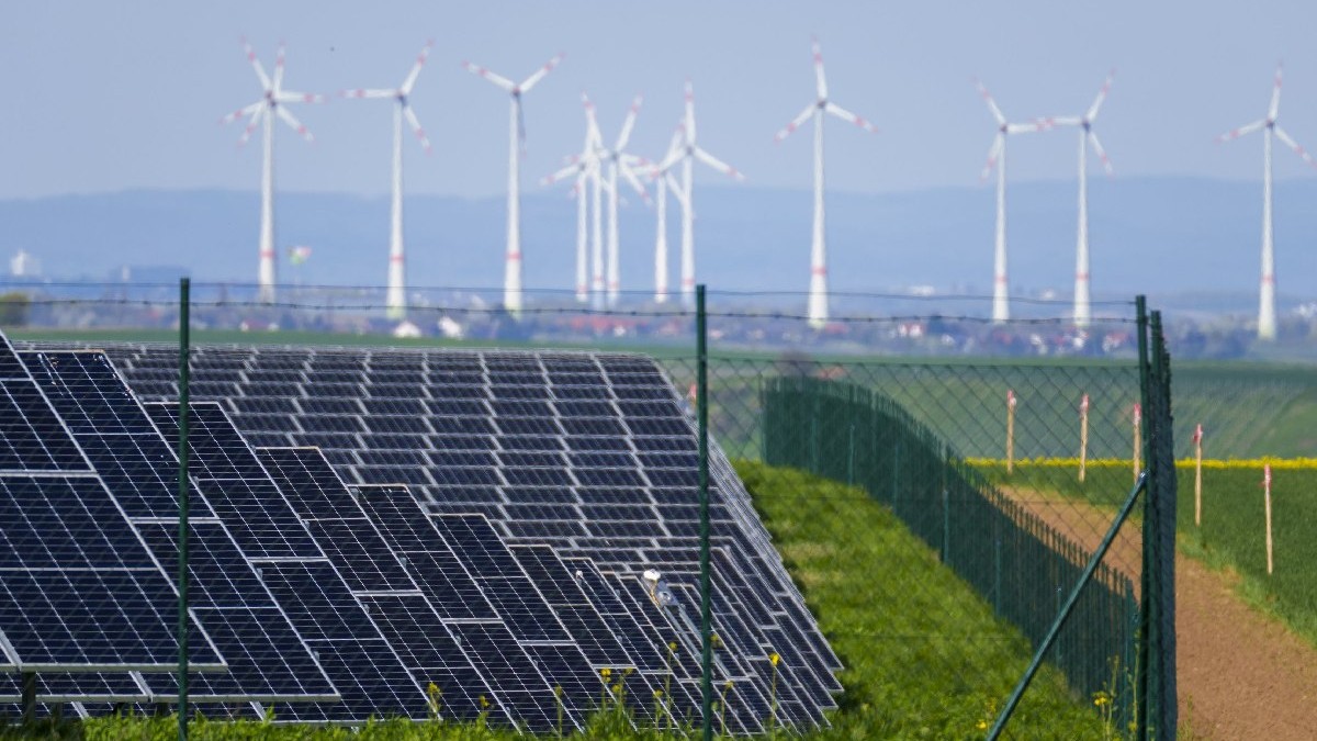Parc solar situat lângă turbine eoliene în Wahlheim, Germania.