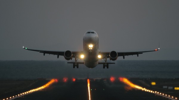 Un avion care aterizează pe seară.