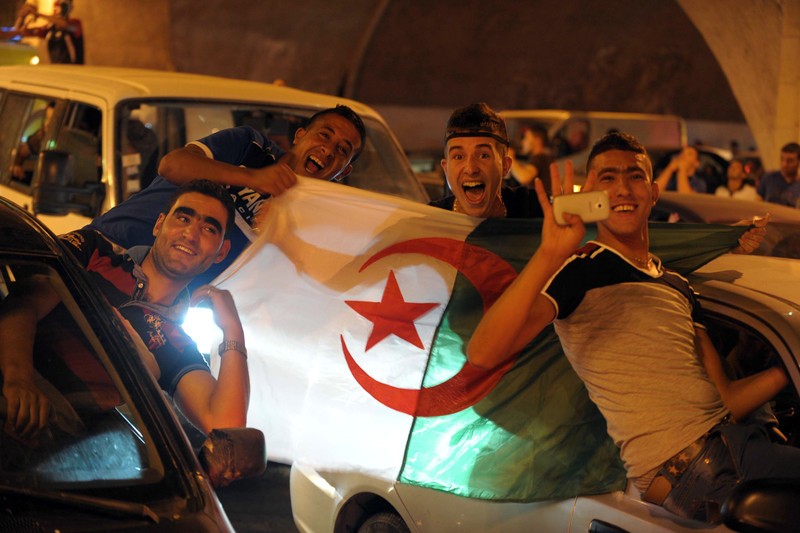 epa04273589 Algerian fans in Algiers, Algeria, 22 June 2014, celebrate after their team won the FIFA 2014 World Cup preliminary round match match between Algeria and South Korea played in Porto Alegre, Brazil. Algeria won the game 4-2. EPA/STR