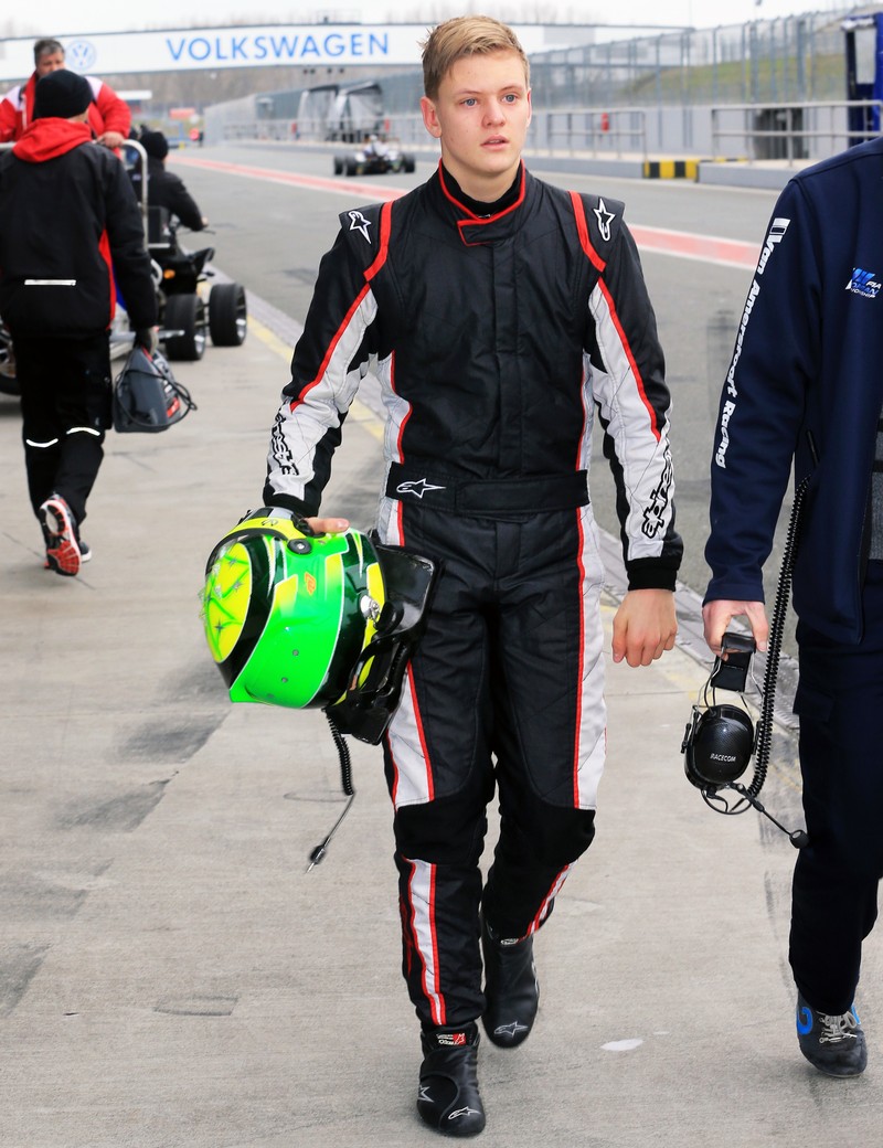 epa04695263 German 16-year-old racing driver Mick Schumacher of Dutch team 'Van Amersfoort Racing' walks through the pit lane at the Motorsport Arena in Oschersleben, Germany, 08 April 2015. Mick Schumacher is the son of German Formula 1 legend Michael Schumacher. EPA/JENS WOLF