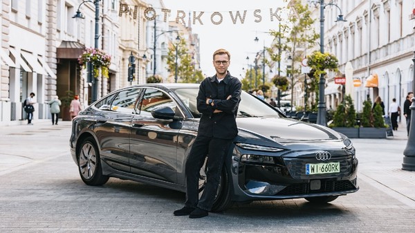 Pilotul Miko Marczyk lângă un Audi A6 electric, negru