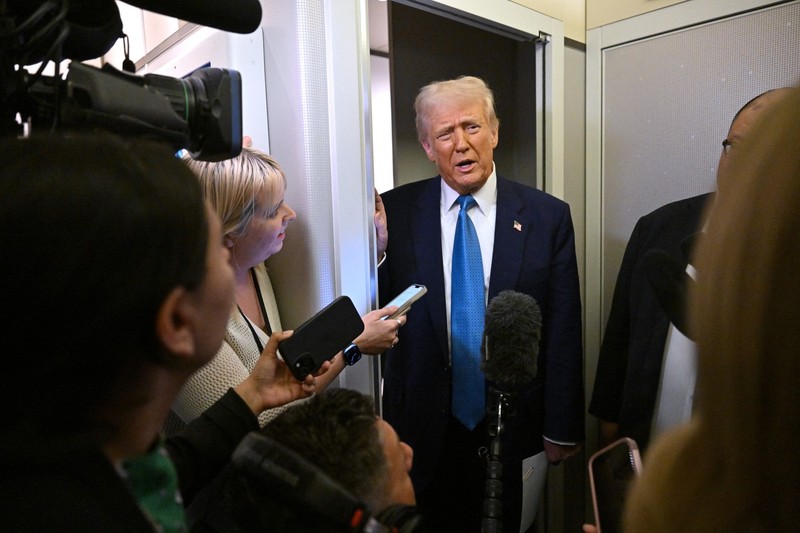US President Donald Trump speaks with journalist on board Air Force One on route from Miami, Florida, to the White House in Washington, DC on February 19, 2025.,Image: 966225837, License: Rights-managed, Restrictions: , Model Release: no