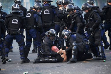 epa04913470 A Hungarian soccer fan is detained by Hungarian police officers prior to the UEFA Euro 2016 qualifying Group F soccer match between Hungary and Romania in the Groupama Arena, Budapest, Hungary, 04 September 2015. EPA/JANOS MARJAI HUNGARY OUT