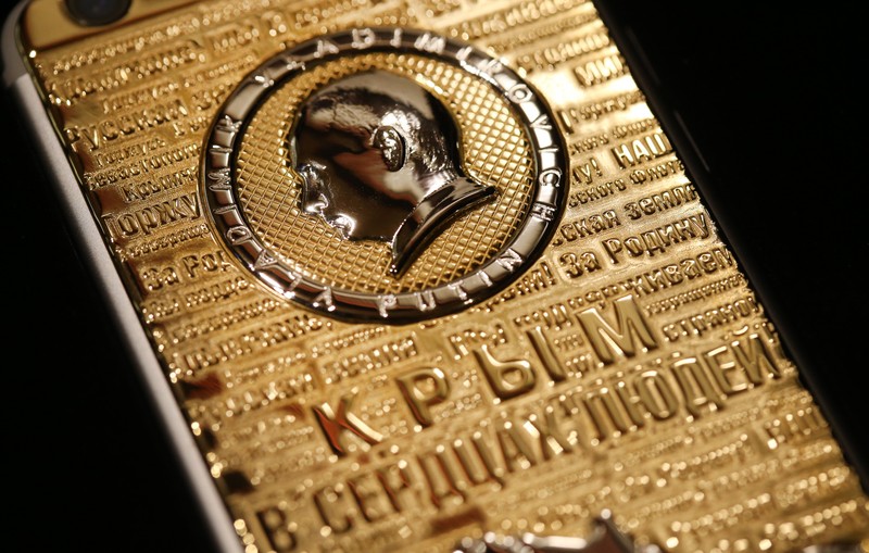 MOSCOW, RUSSIA. MARCH 18, 2016. A Caviar iPhone 6s Supremo Putin Crimea Edition Gold garnished and marketed by Russian-Italian jewellery brand Caviar, commemorates the 2014 reunification of Crimea with Russia. The back of the phone features a likeness of Russian president Vladimir Putin, a map of Crimea, and phrases reflecting reactions of Russian people to the reunification. The price of the phone varies between 199 and 209 thousand Russian roubles. PHOTOGRAPH BY TASS / Barcroft Media UK Office, London. T +44 845 370 2233 W www.barcroftmedia.com USA Office, New York City. T +1 212 796 2458 W www.barcroftusa.com Indian Office, Delhi. T +91 11 4053 2429 W www.barcroftindia.com March , 2016 *** Local Caption *** 02463368