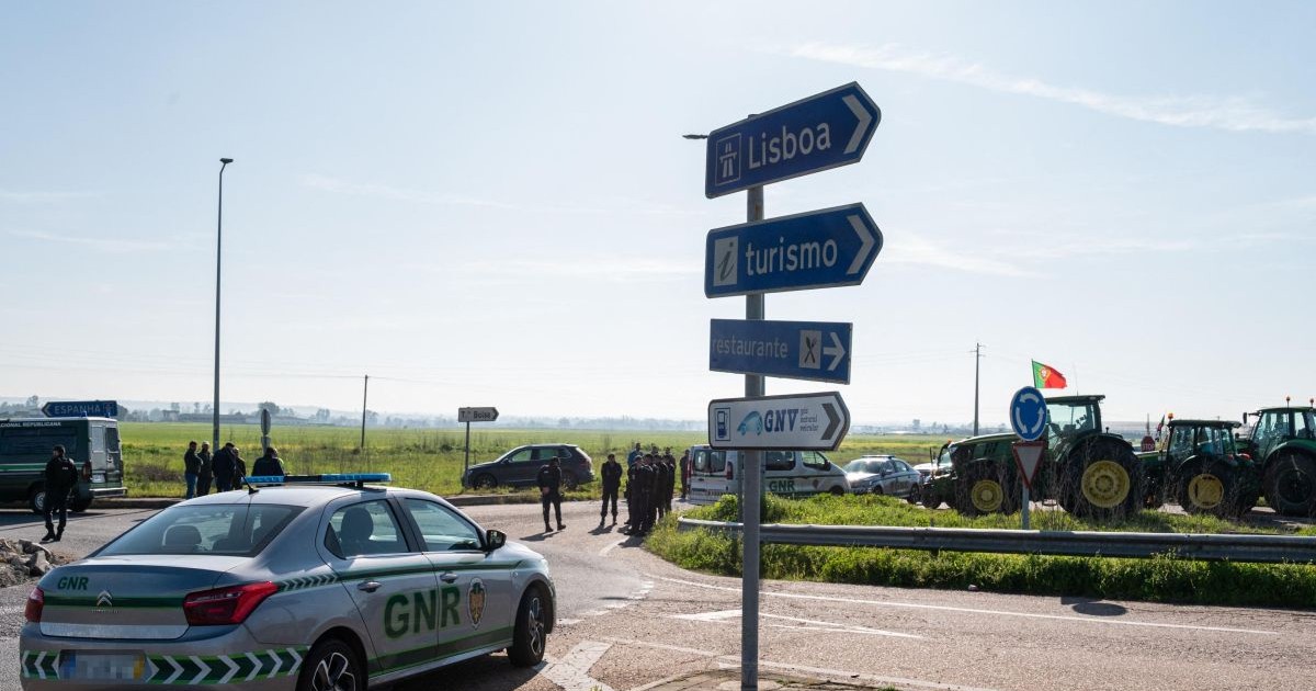 O mașină a poliției portugheze este parcată în apropierea unei autostrade blocate de fermieri, în apropierea graniței cu Spania, februarie 2024