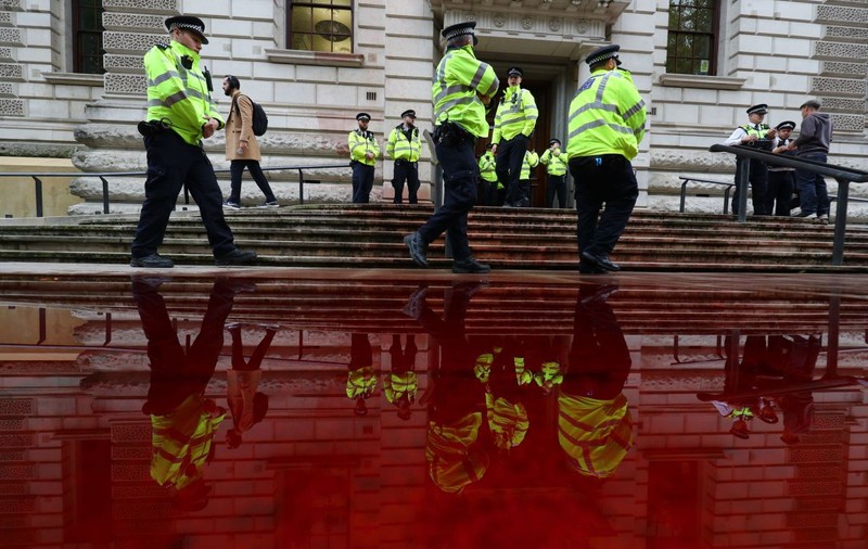 VIDEO | Protest cu „sânge fals” în Londra. Manifestanții au vrut să stropească sediul Ministerul de Finanțe, însă vopseaua a ajuns pe șosea