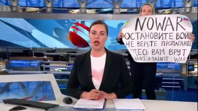 Marina Ovsiannikova, în spate, cu bannerul antirăzboi