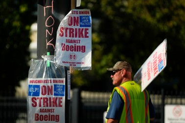 Signs are taped to a light pole as Boeing workers strike Tuesday, Sept. 24, 2024, outside the company's factory in Renton, Wash.,Image: 911507359, License: Rights-managed, Restrictions: This content is intended for editorial use only. For other uses, additional clearances may be required., Model Release: no