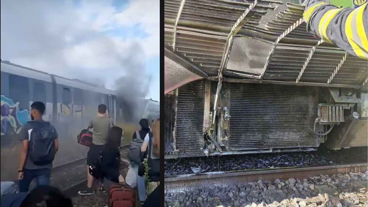 Mai mulți oameni stau lângă un tren din care iese fum