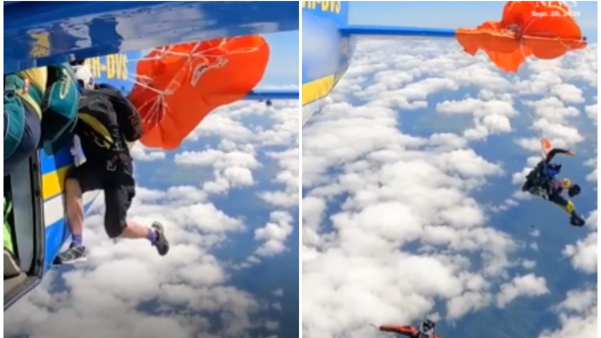 Un bărbat care a rămas agățat cu parașuta portocalie de avion, în aer.