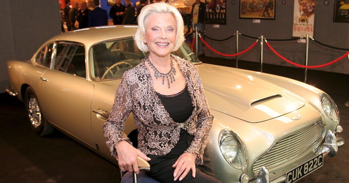 epa00567781 Honor Blackman, who played Bond girl Pussy Galore in the James Bond film "Goldfinger", is reunited with the car which starred in the film, an Aston Martin DB5 at the Vintage Car Show being held at the NEC in Birmingham, Friday 04 November 2005. EPA/Stephen Pond UK &amp; Ireland Out