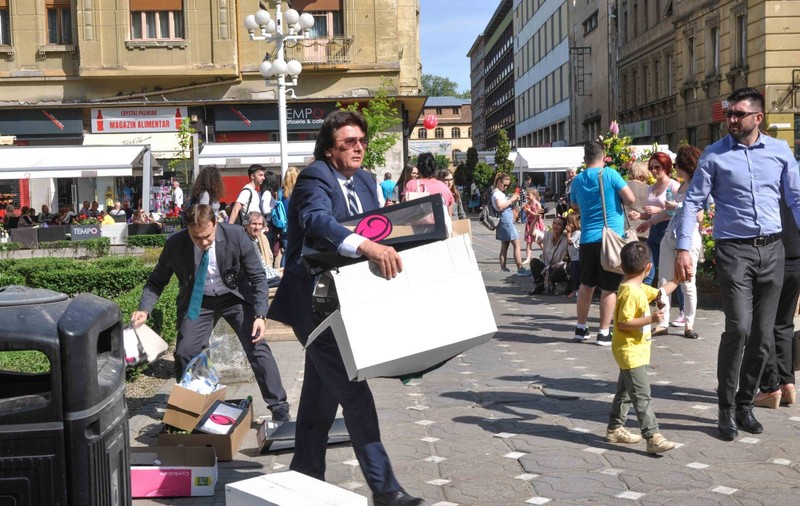 Primarul Nicolae Robu a cărat gunoaie în centrul Timișoarei, la costum și cravată. Imaginile, surprinse înaintea deschiderii unui festival/ FOTO