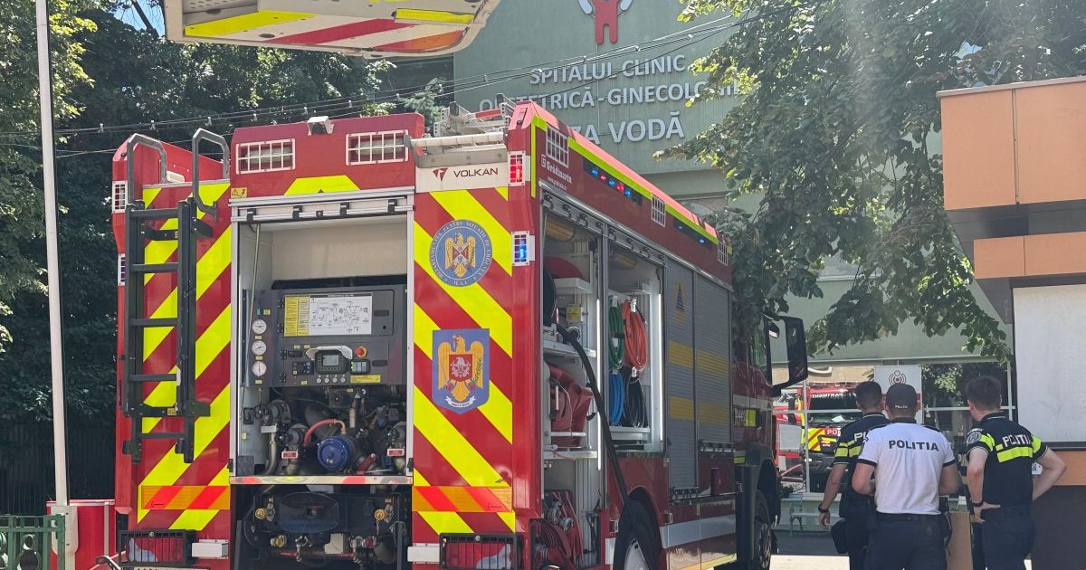 O mașină de pompieri staționaeză în fața maternității Cuza Vodă din Iași, după ce o anexă a spitalului a luat foc, 23 iulie 2025