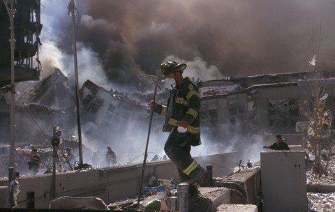 Un pompier din New York, în timp ce escaladează ruinele World Trade Center, după atacurile de la 11 Septembrie
