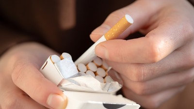 A,Man,Holds,A,Pack,Of,Cigarettes,In,His,Hands,