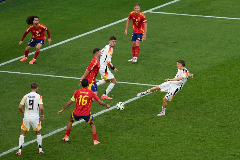 Germany's Florian Wirtz, right, scores his side's first goal during a quarter final match between Germany and Spain at the Euro 2024 soccer tournament in Stuttgart, Germany, Friday, July 5, 2024.,Image: 887538050, License: Rights-managed, Restrictions: This content is intended for editorial use only. For other uses, additional clearances may be required., Model Release: no, Pictured: Florian Wirtz