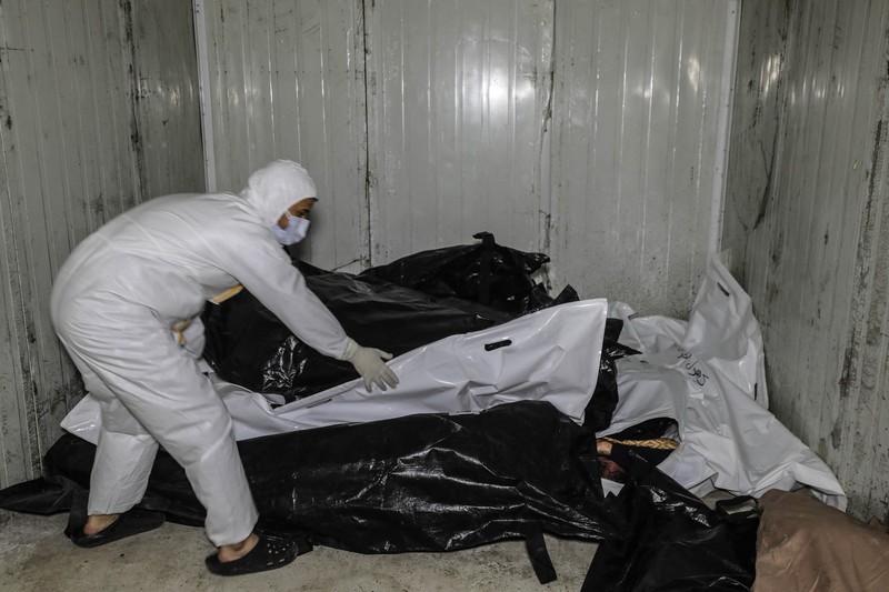 DAMASCUS, SYRIA - DECEMBER 10: (EDITOR'S NOTE: Image depicts death) A view of dead bodies, who were tortured to death, at Al-Mujtahid Hospital as teams carry out investigation in secret compartments at Sednaya Prison after the fall of the Assad regime in Damascus, Syria on December 10, 2024. Anadolu reporters in Damascus documented efforts of the Syrian Civil Defense, known as the White Helmets, as they worked to uncover the hidden chambers at the prison. Bodies were stamped with numbers on their shrouds in accordance with the codes in prisons, but without names. Izettin Kasim / Anadolu,Image: 945012089, License: Rights-managed, Restrictions: , Model Release: no