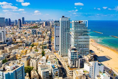 TEL AVIV, ISRAEL - JUNE 3, 2021: Skyscraper hotels on the waterfront, azure Mediterranean Sea, beautiful beaches. Beautiful city Tel Aviv on a hot summer day. Photo taken from aerial view