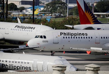 epa08302663 Philippine Airlines (PAL) plane are seen parked on the tarmac at Ninoy Aquino International Airport in Manila, Philippines, 18 March 2020. Philippine President Rodrigo Duterte gave foreign travelers a 72-hour deadline for leaving the country after placing it under a state of calamity to contain the spread of coronavirus. EPA-EFE/FRANCIS R. MALASIG