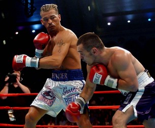 Arturo Gatti, left, boxes Leonard Dorin, of Montreal, Canada in the first round of the of the WBC Super Lightweight Championship at Boardwalk Hall in Atlantic City, N.J. Saturday, July 24, 2004. Gatti knocked out Dorin in the second round to retain his title (AP Photo/Brian Branch-Price)