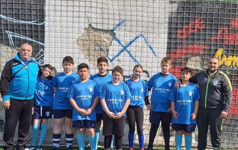Gafa CSM Bucureşti, pe contul oficial: Poză cu juniorii de la rugby în fața unui zid pe care era desenată o svastică