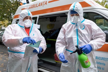 Lucian şi Andrei se dezinfectează după o intervenţie la un caz de Covid-19