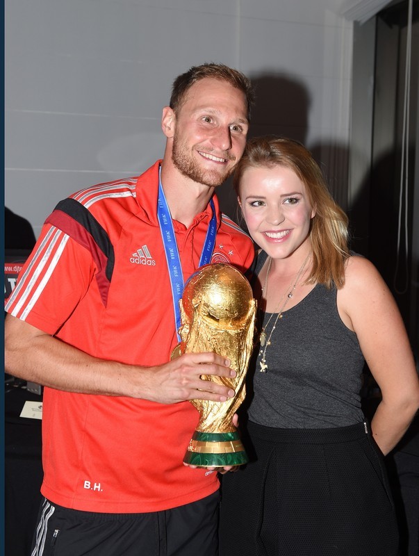 epa04315363 A handout photo released by the DFB (German Soccer Association) on 14 July 2014 shows German player Benedikt Hoewedes and his girlfriend Lisa Wesseler celebrating Germany's victory over Argentina in the FIFA World Cup 2014 with the trophy in Rio De Janeiro, Brazil, 13 July 2014. Germany won the World Cup after defeating Argentina 1-0. EPA/MARKUS GILLIAR / HANDOUT HANDOUT EDITORIAL USE ONLY/NO SALES HANDOUT EDITORIAL USE ONLY/NO SALES HANDOUT EDITORIAL USE ONLY/NO SALES