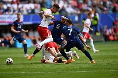 HAMBURG, GERMANY - JUNE 16: Xavi Simons (7) and Memphis Depay (10) of Netherlands in action against Piotr Zielinski (ground) of Poland during the 2024 European Football Championship (EURO 2024) Group D football match between Poland and Netherlands at Volksparkstadion Hamburg in Hamburg, Germany on June 16, 2024. Halil Sagirkaya / Anadolu/ABACAPRESS.COM