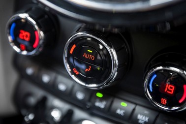 Color detail with the air conditioning button inside a car.