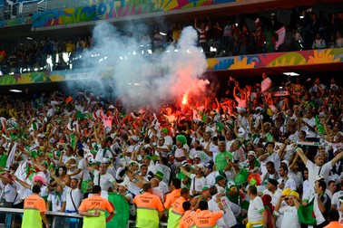epa04284463 Algerian fans light flares as they celebrate a goal during the FIFA World Cup 2014 group H preliminary round match between Algeria and Russia at the Arena da Baixada in Curitiba, Brazil, 26 June 2014. (RESTRICTIONS APPLY: Editorial Use Only, not used in association with any commercial entity - Images must not be used in any form of alert service or push service of any kind including via mobile alert services, downloads to mobile devices or MMS messaging - Images must appear as still images and must not emulate match action video footage - No alteration is made to, and no text or image is superimposed over, any published image which: (a) intentionally obscures or removes a sponsor identification image; or (b) adds or overlays the commercial identification of any third party which is not officially associated with the FIFA World Cup) EPA/CJ GUNTHER EDITORIAL USE ONLY