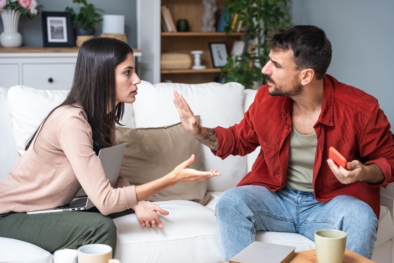 Young couple at home have a problem and argue due to jealousy caused by chatting and flirting via social media networks on smart phones, relationship difficulties problems and distrust,Image: 877467581, License: Royalty-free, Restrictions: , Model Release: yes